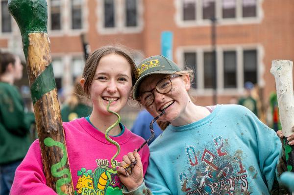 two girls at snake invasion with plastic snakes